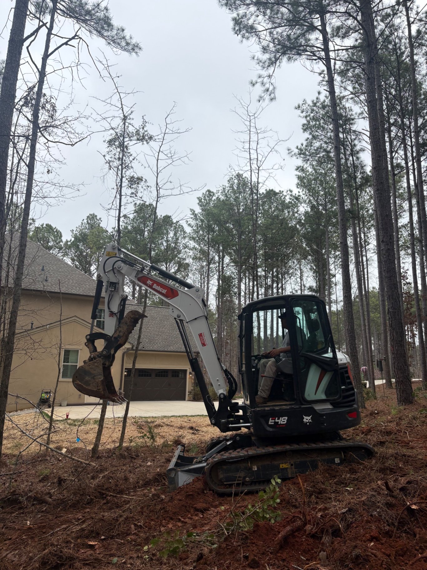 Excavator moving earth on a Charlotte, NC site preparation project